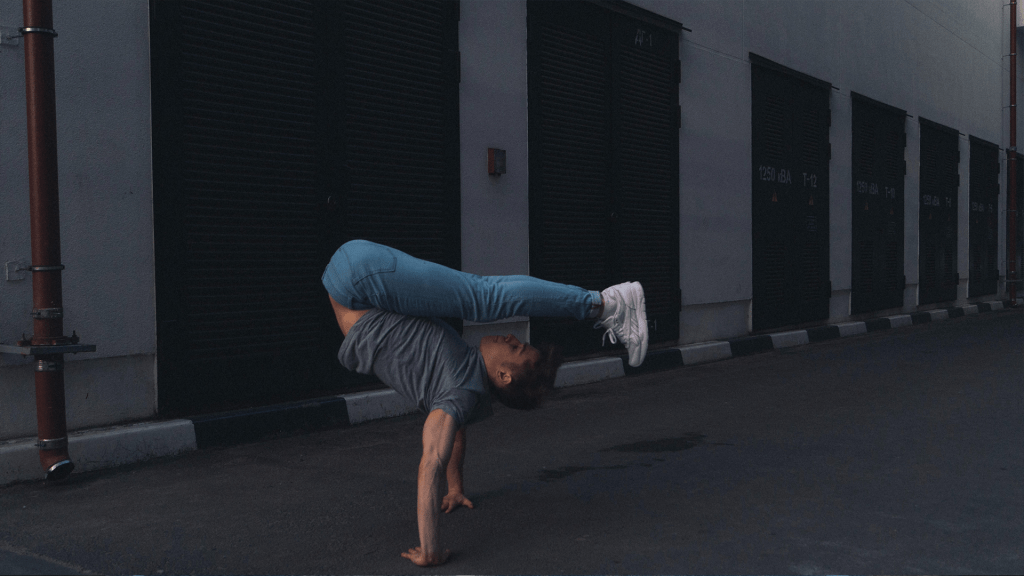 man doing yoga in the street