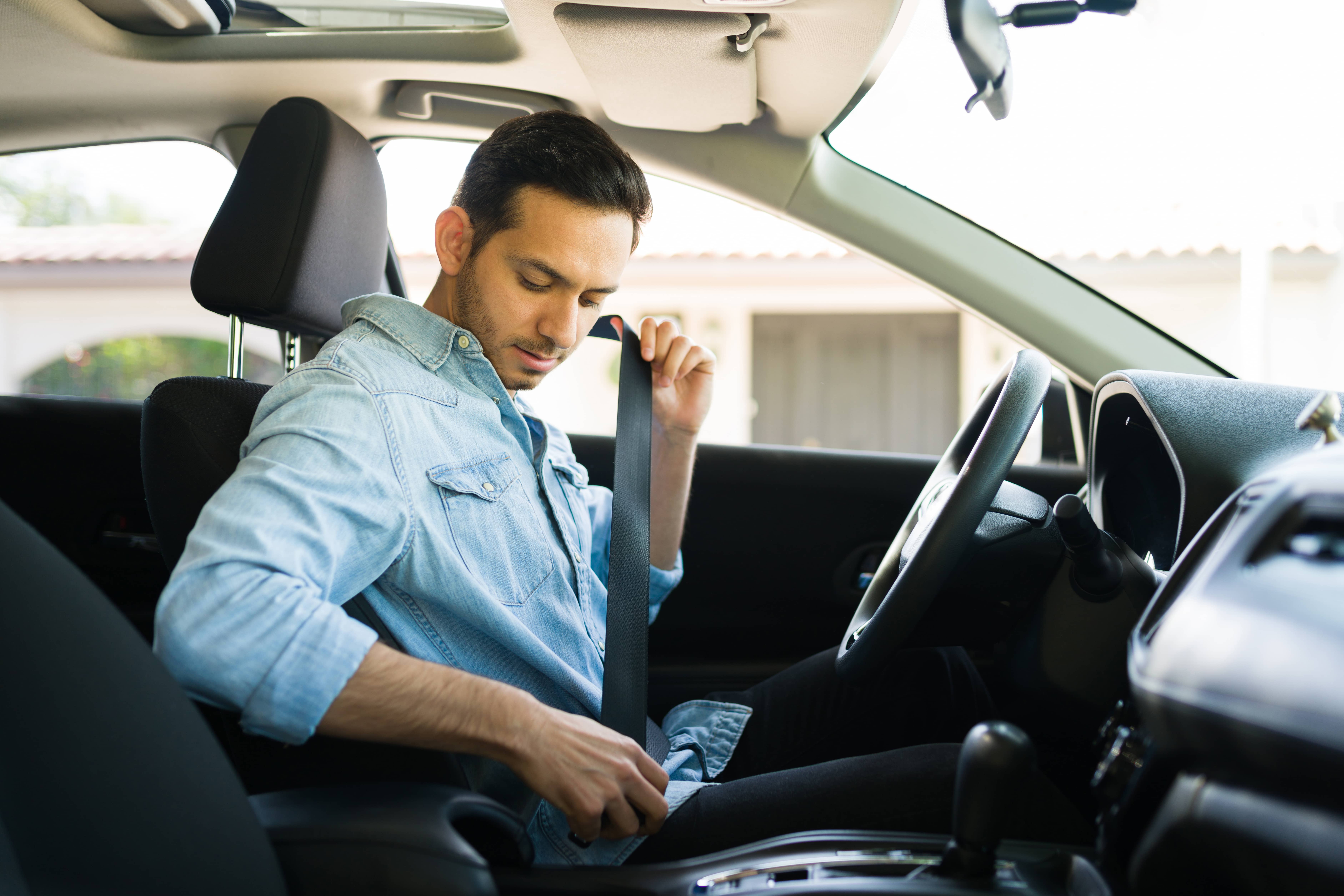 driver putting on seatbelt