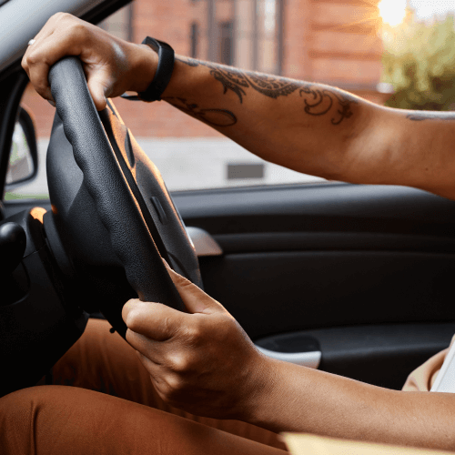 Close up of a person using a steering wheel