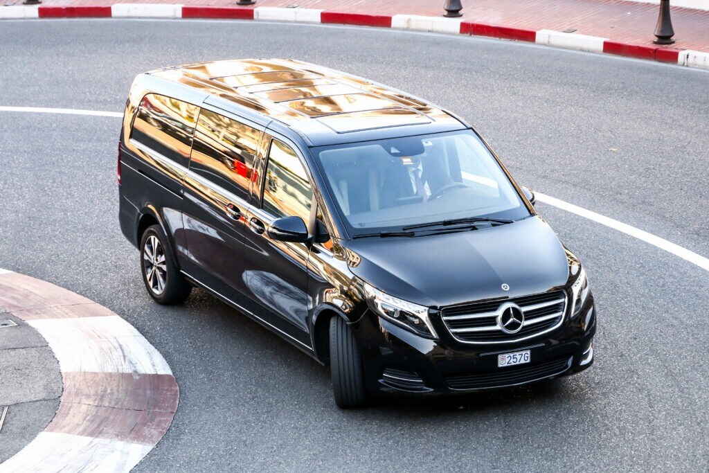 Black passenger van Mercedes-Benz W447 Viano in the city street.