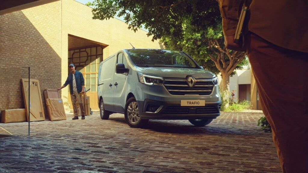 A grey delivery van parked on a driveway.