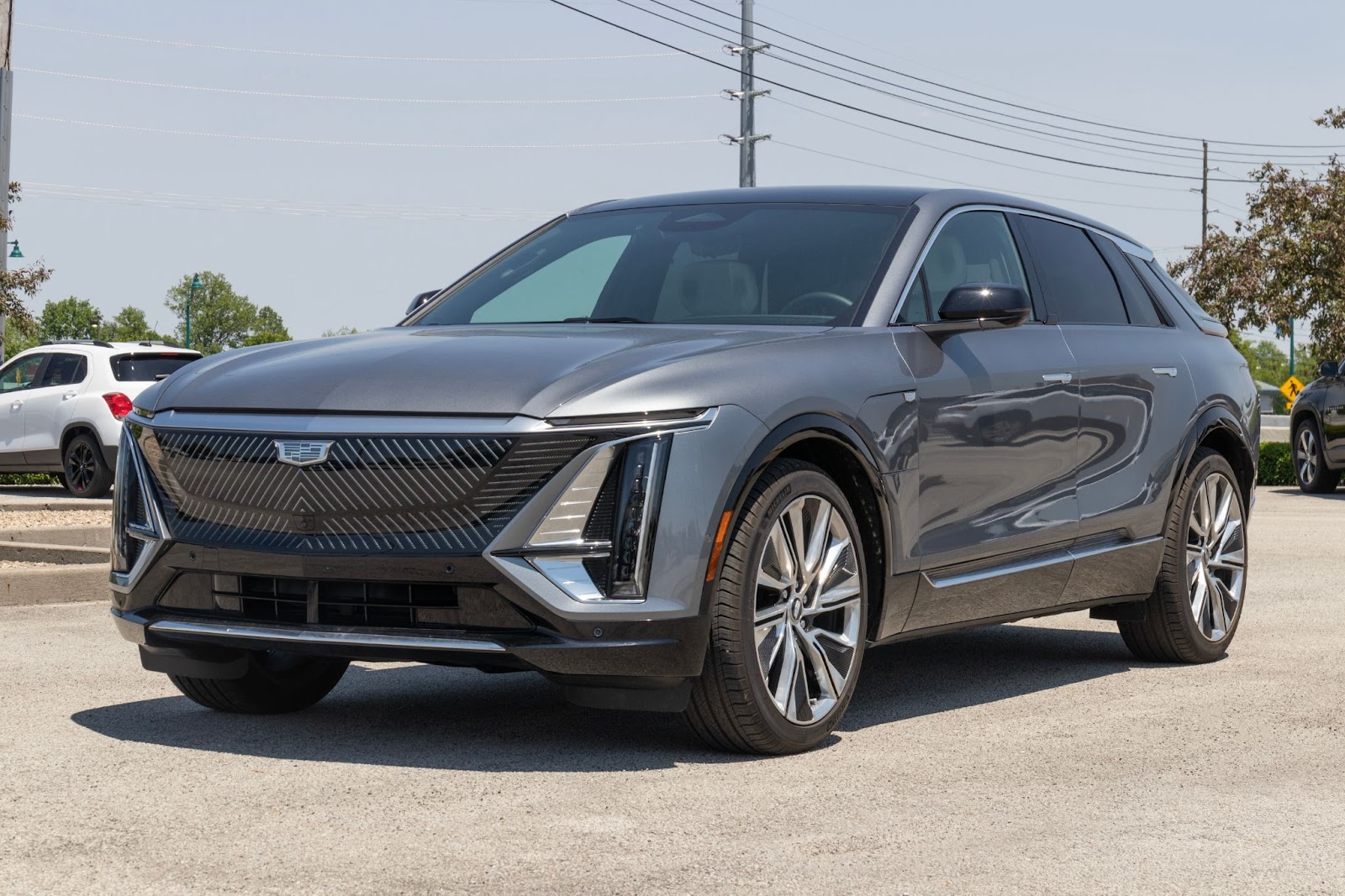 A stationary grey cadillac SUV