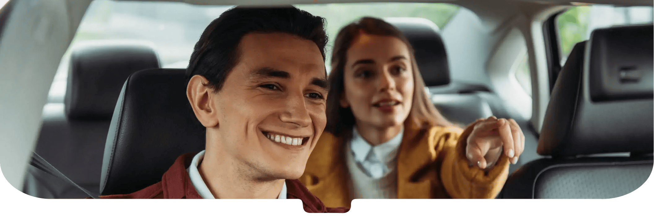 Smiling taxi driver in a burgundy jacket with passenger