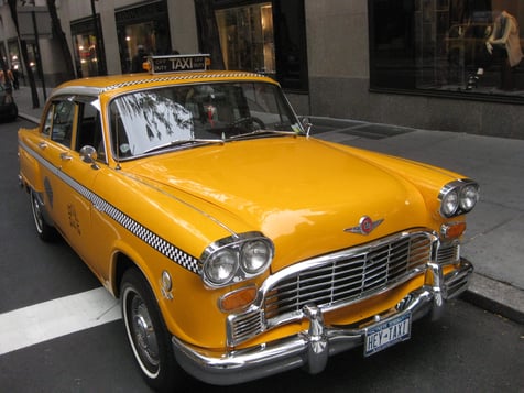 A yellow checkers taxi cab