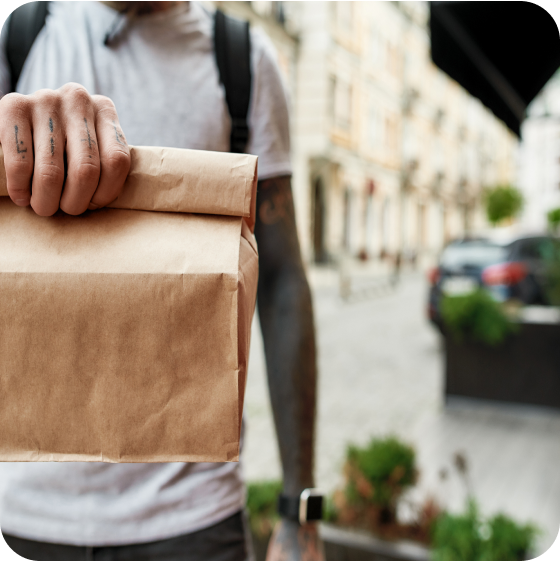 Delivery man holding paper bag