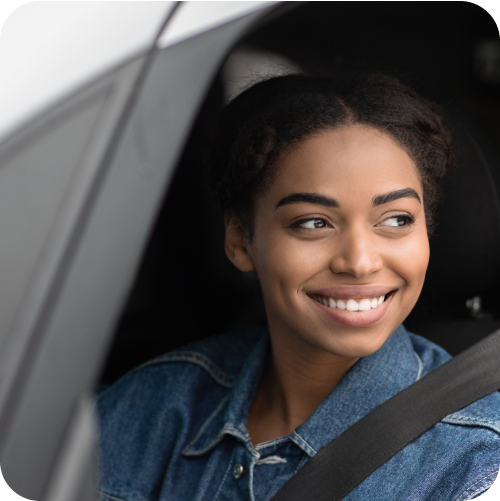 Smiling woman looking out of the driver-side window