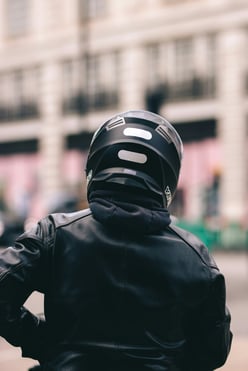 back of a motorbike ride in black helmet and protective clothing