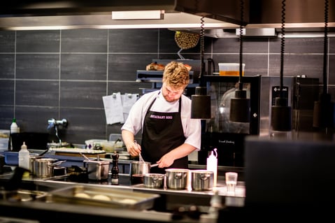 a chef in a kitchen preparing a meal