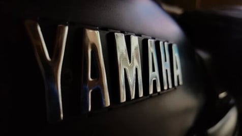 yamaha lettering in silver on a black background