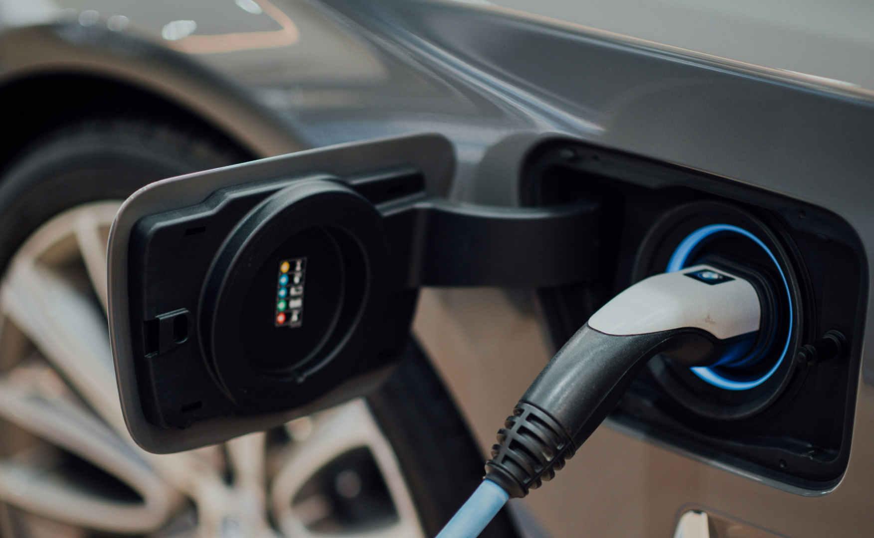 close up of a white charging cable plugged into a vehicle