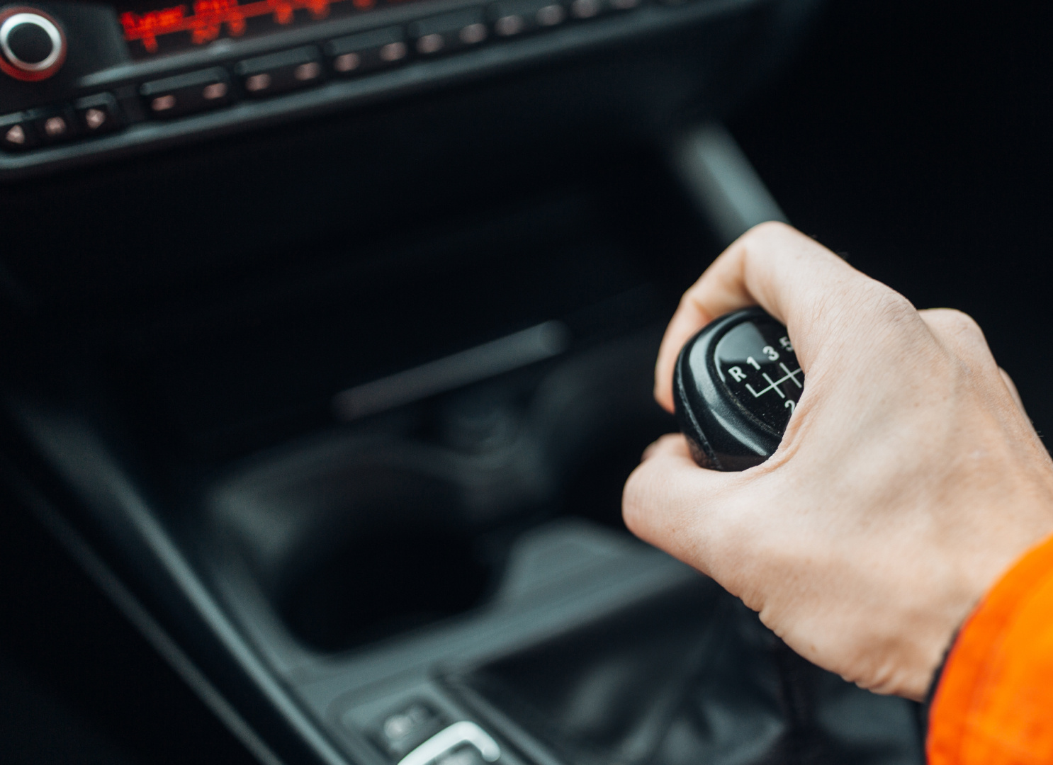 a person holding a gear stick