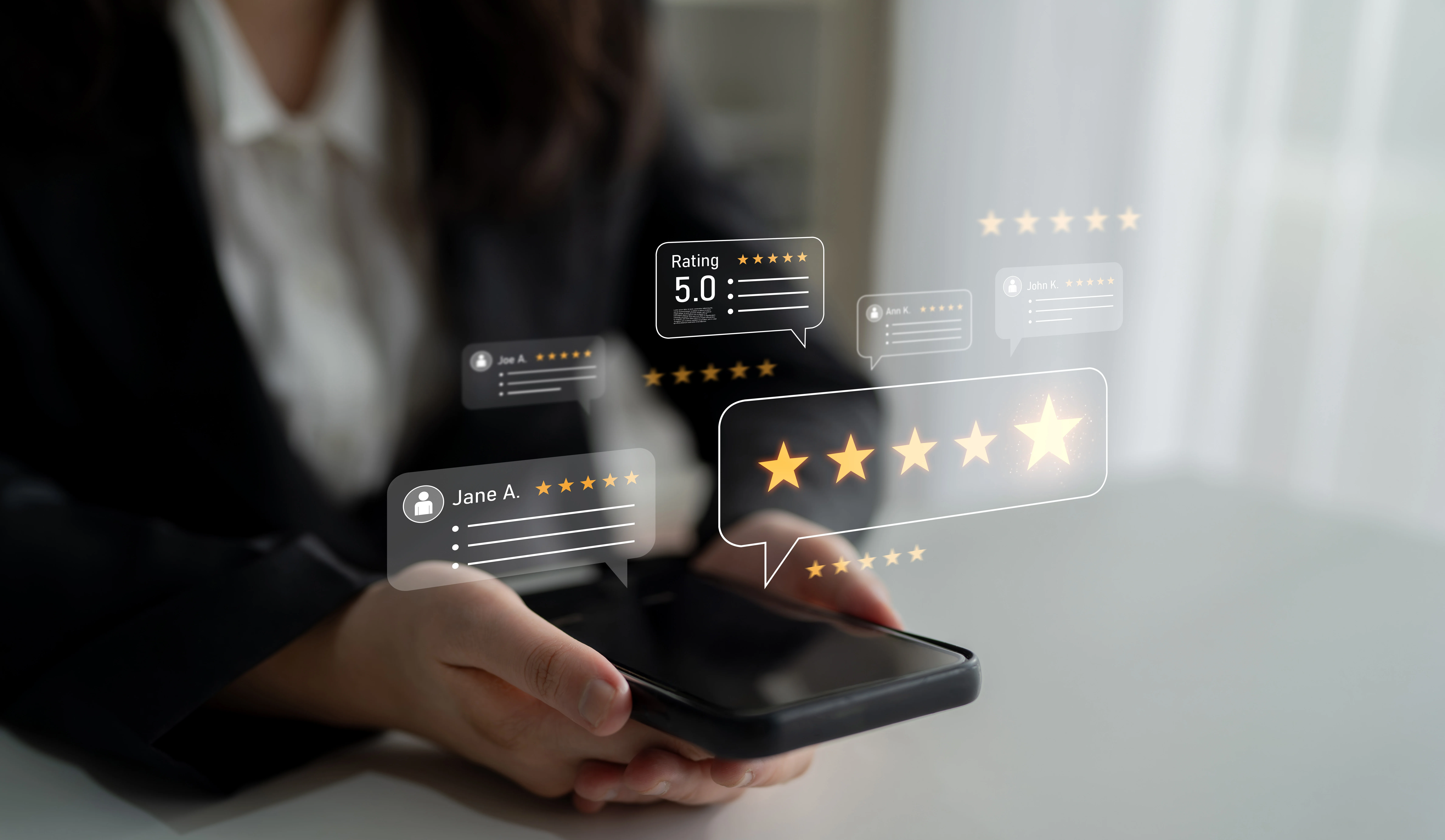 Woman holding phone displaying five star reviews