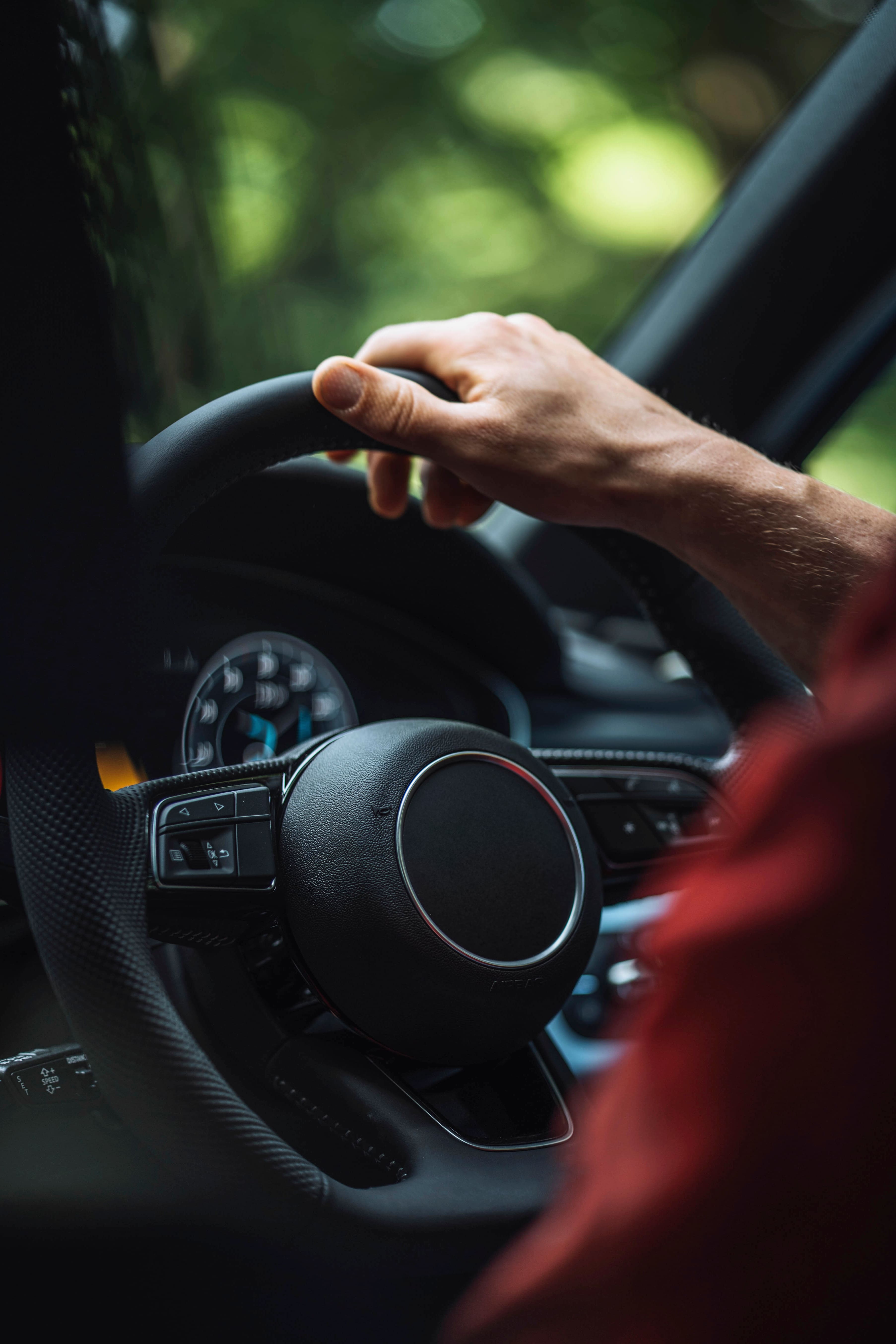 hand on the steering wheel of a car 