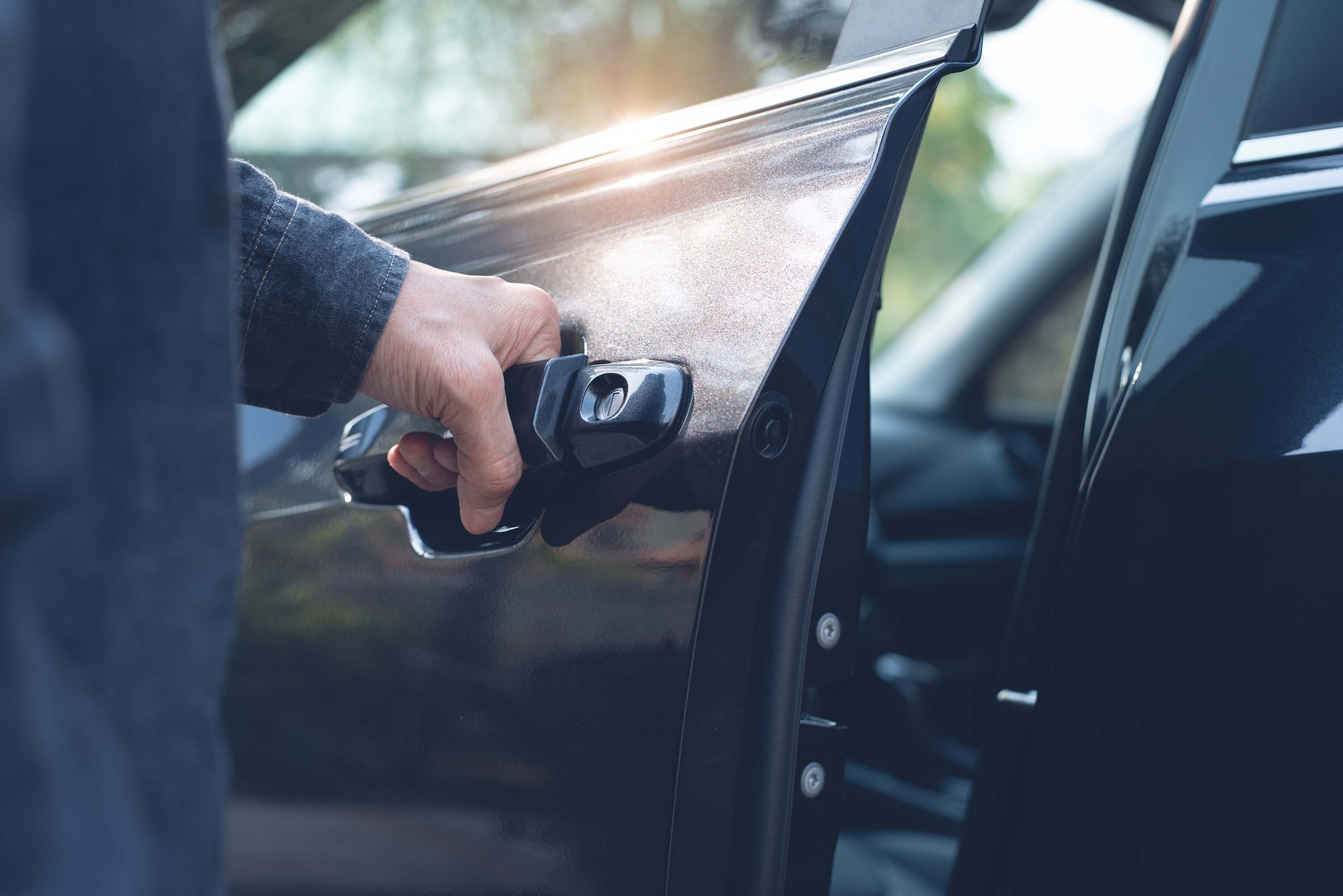 a person opening a car door