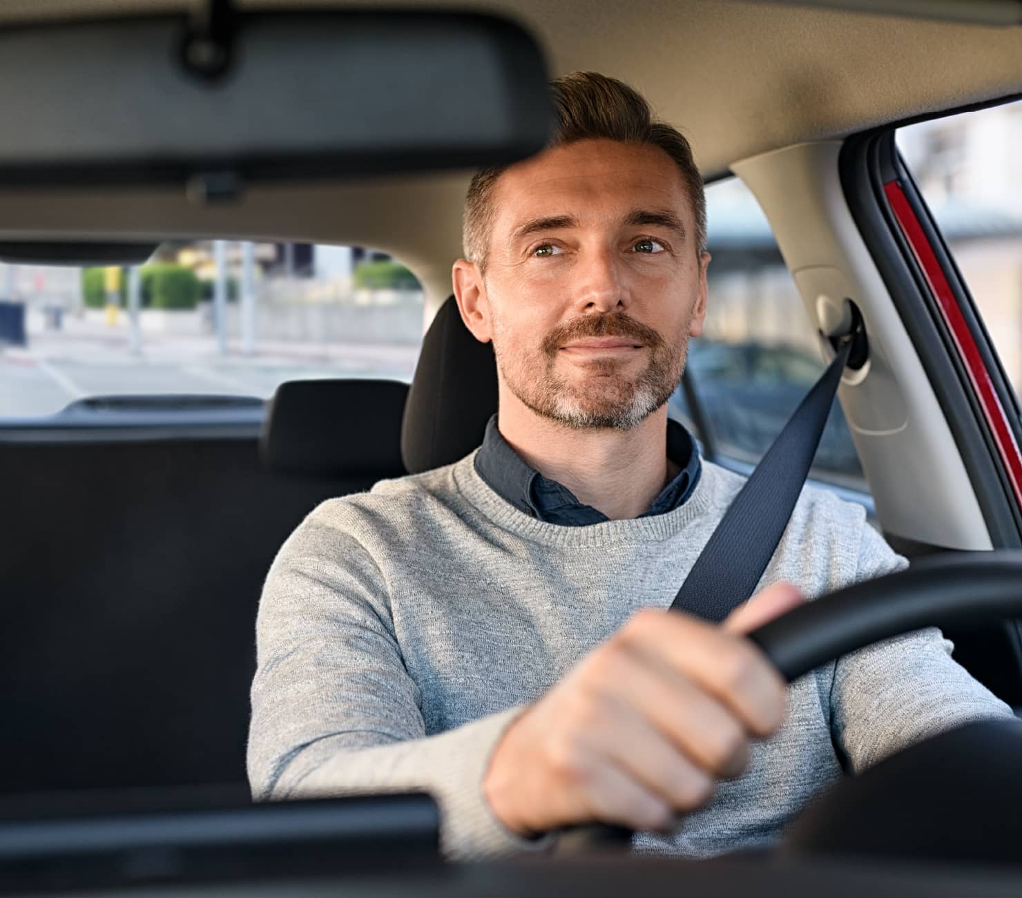 driver looking at rear view mirror