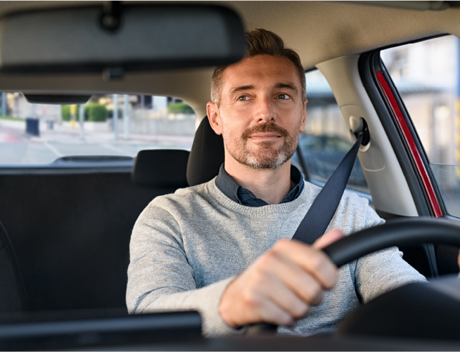 driver looking at rear view mirror