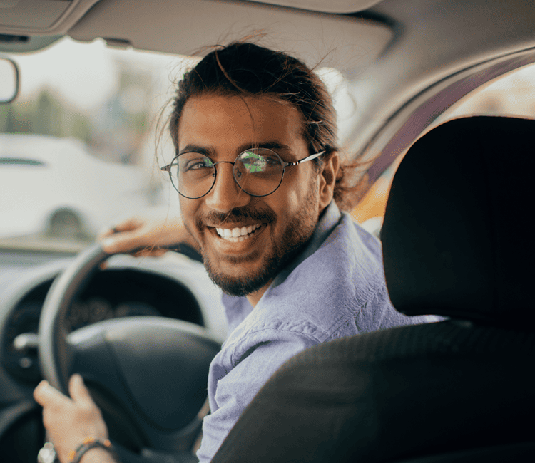 Driver-looking-back-and-smiling-in-car (2)