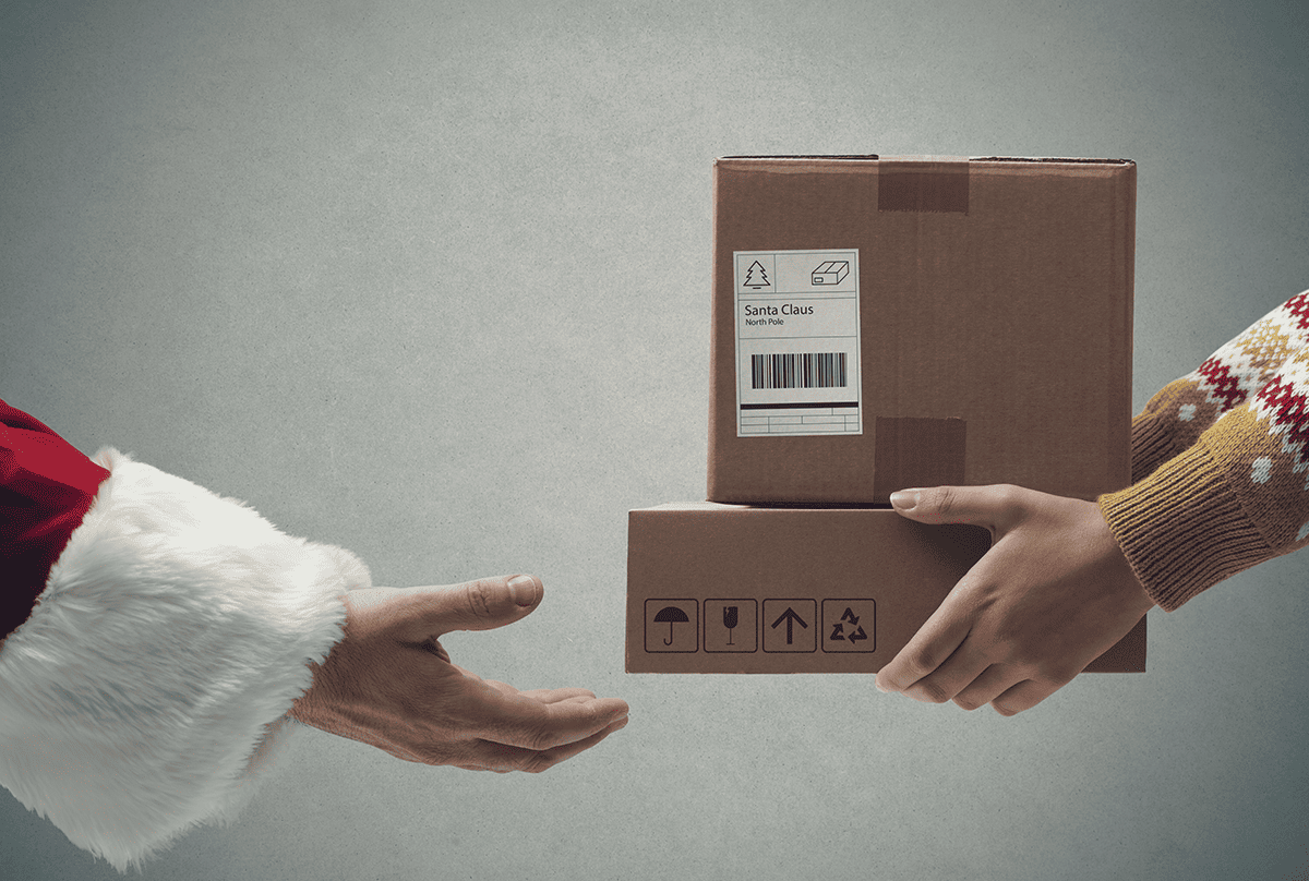 Delivery driver handing parcels to Santa 