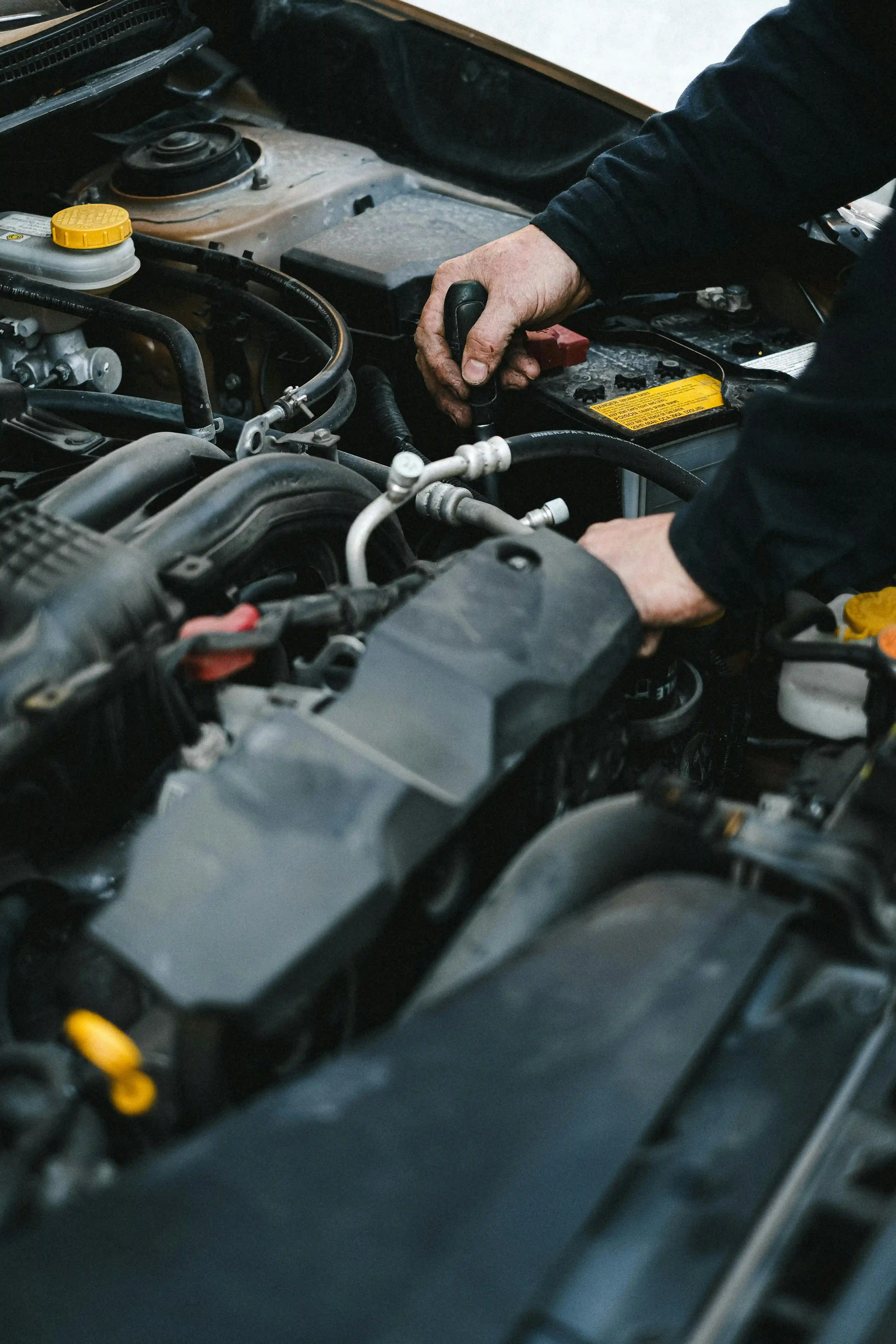 mechanic fixing a vehicle engine