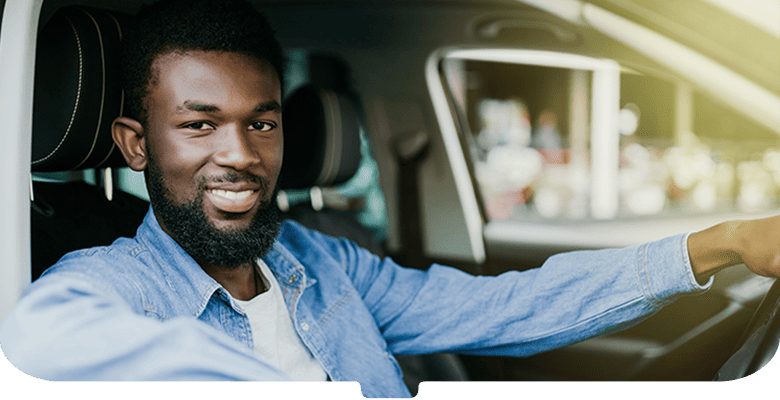 Smiling man leaning out of a car 