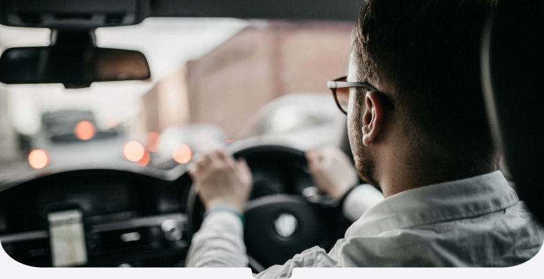 Driver in a white shirt and glasses