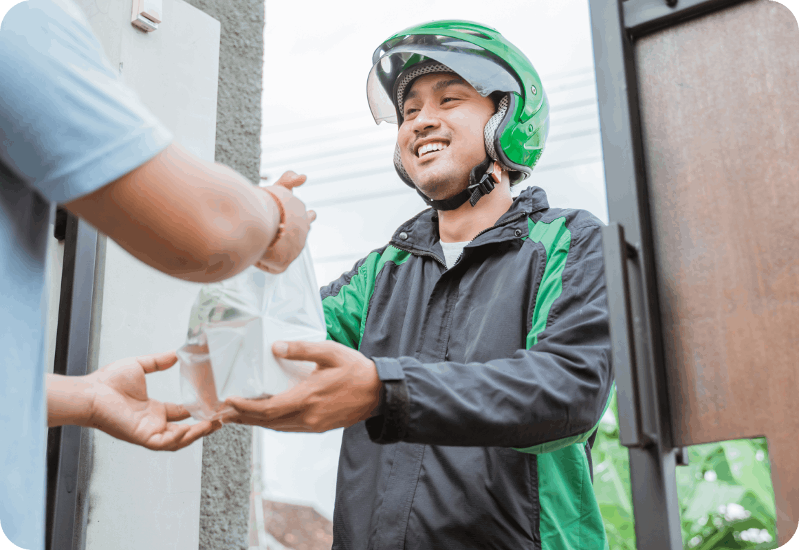 fast food delivery driver handing a customer their fast food order