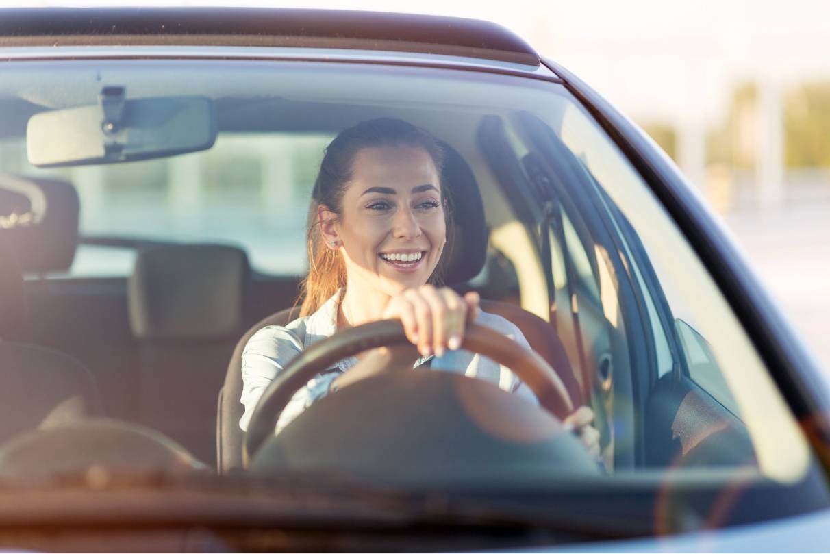 Smiling woman driving car