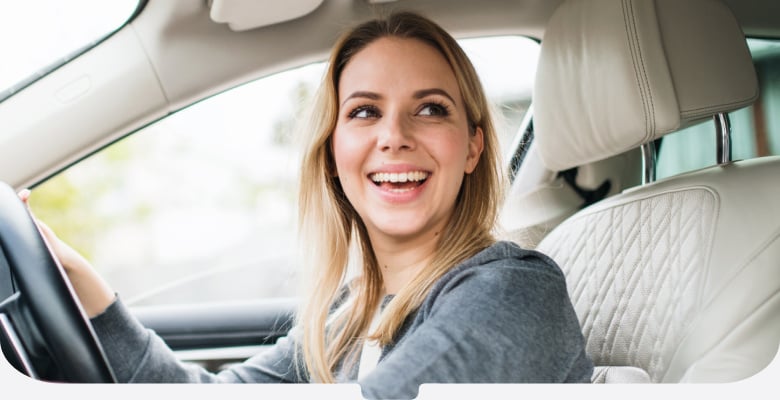 Woman driving car looking to side-mobile