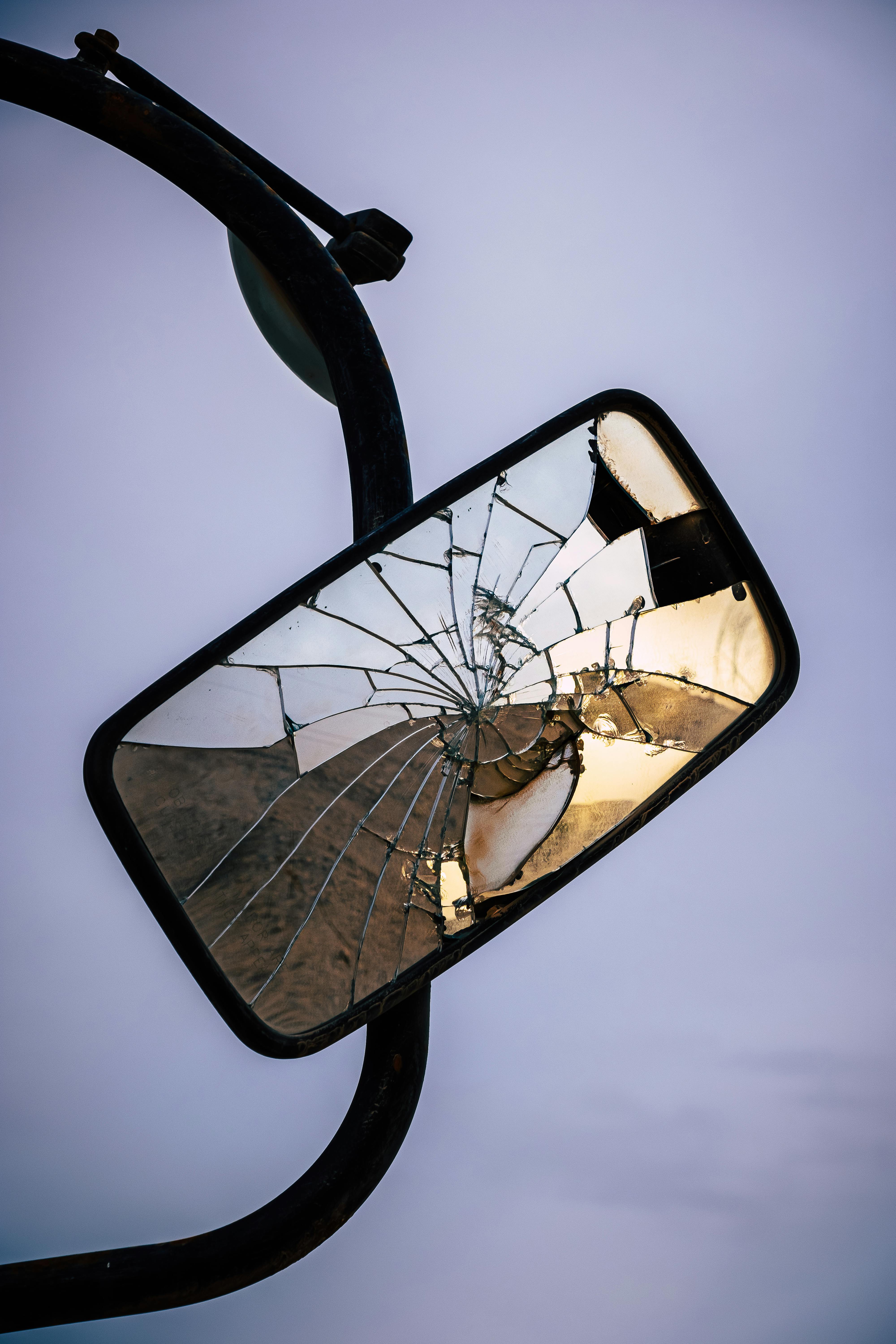 a smashed car mirror on a purple background