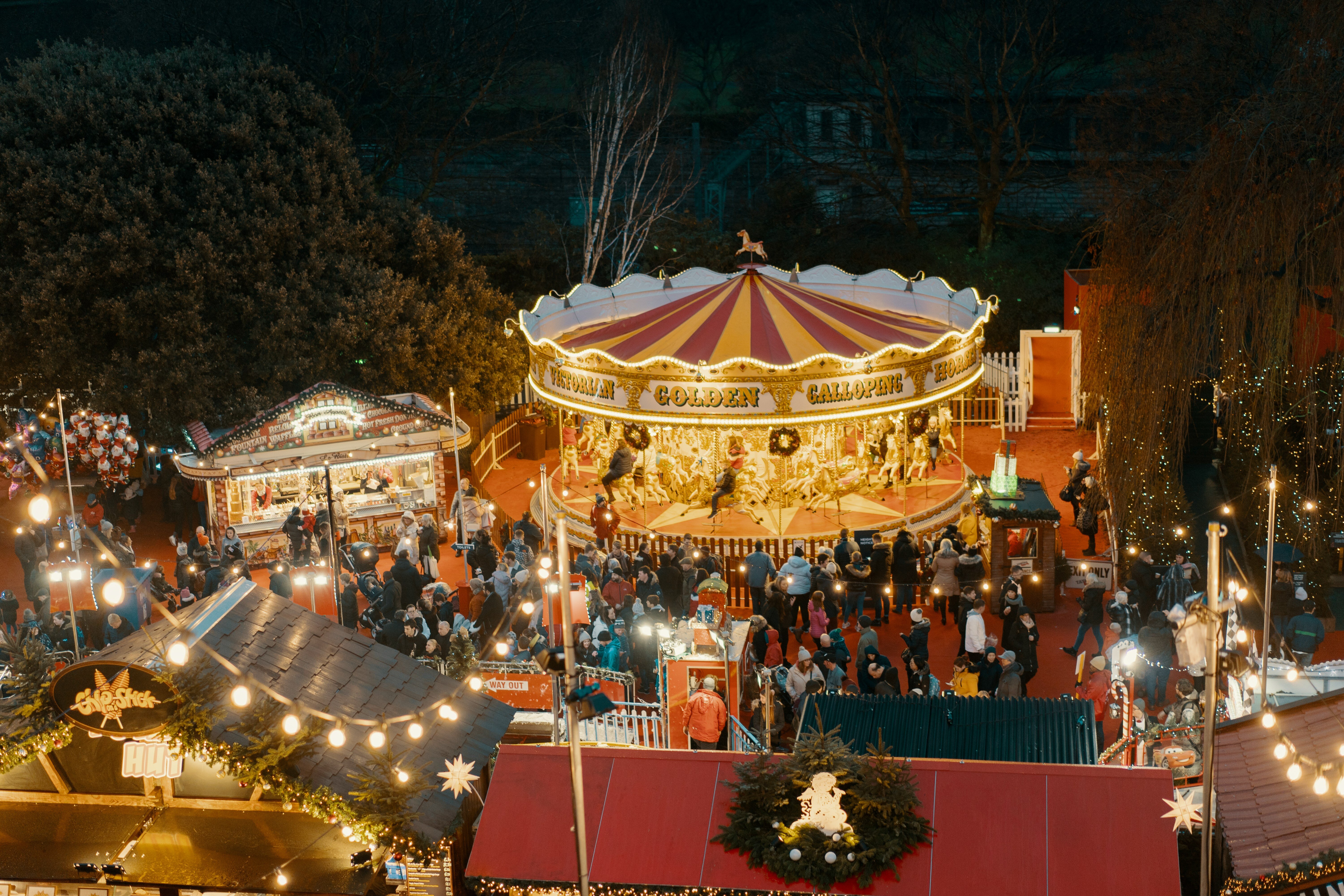 a christmas market at night with carousel